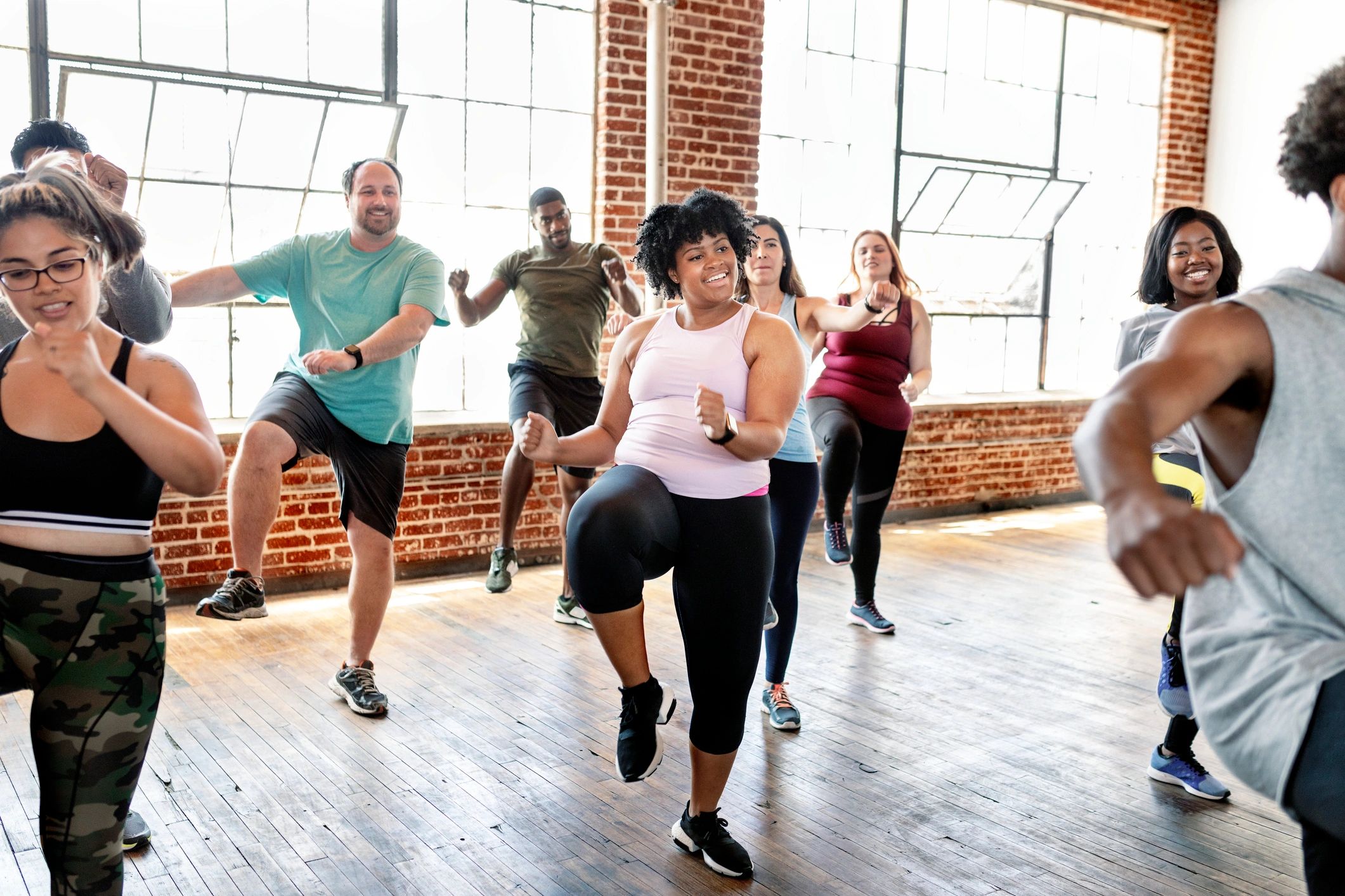 Diverse group jogging in fitness studio